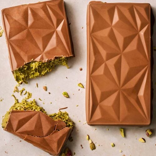 Two homemade chocolate bars with pistachio and pastry filling.