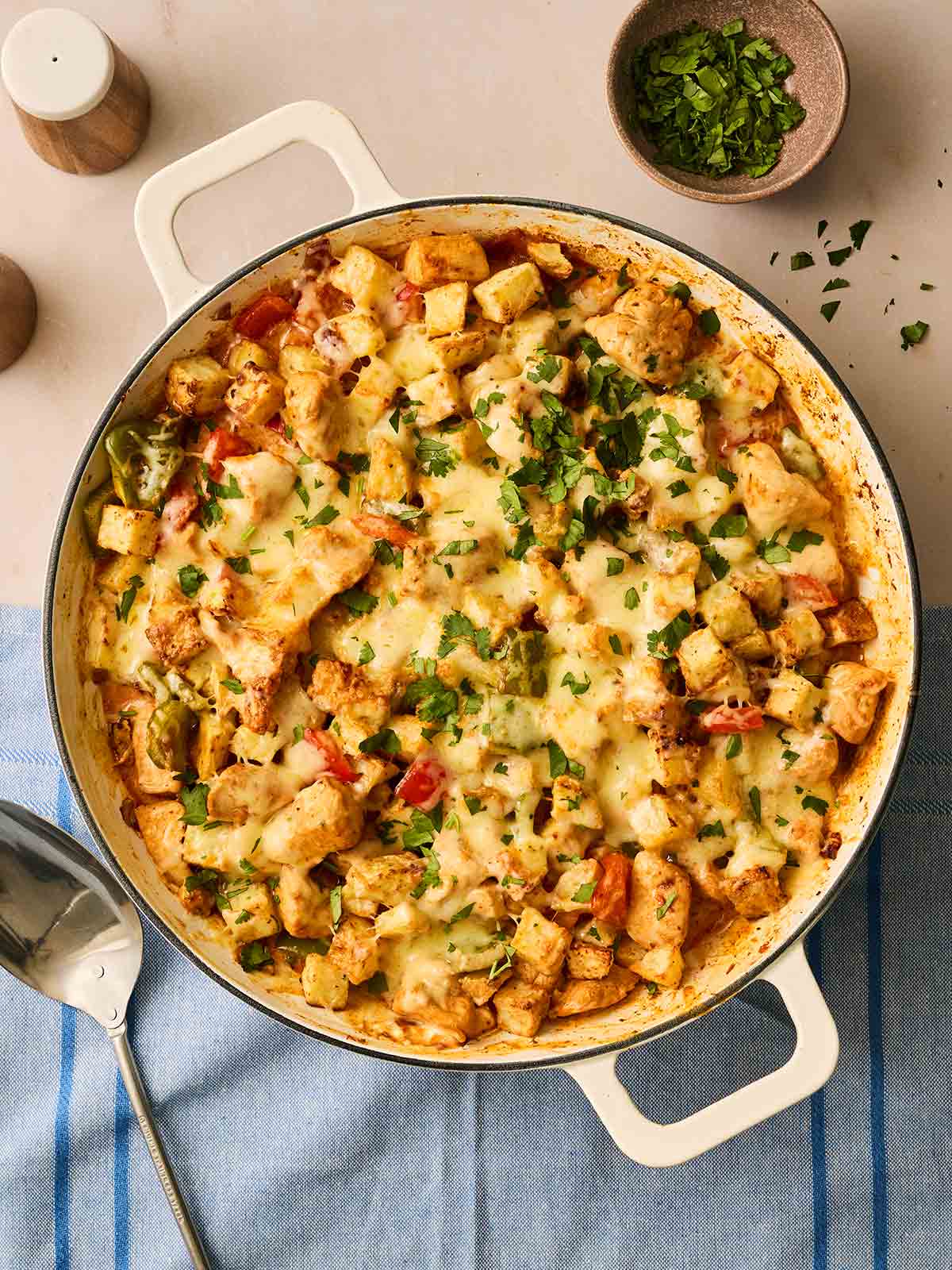 A pan filled with potatoes, chicken in a creamy sauce.