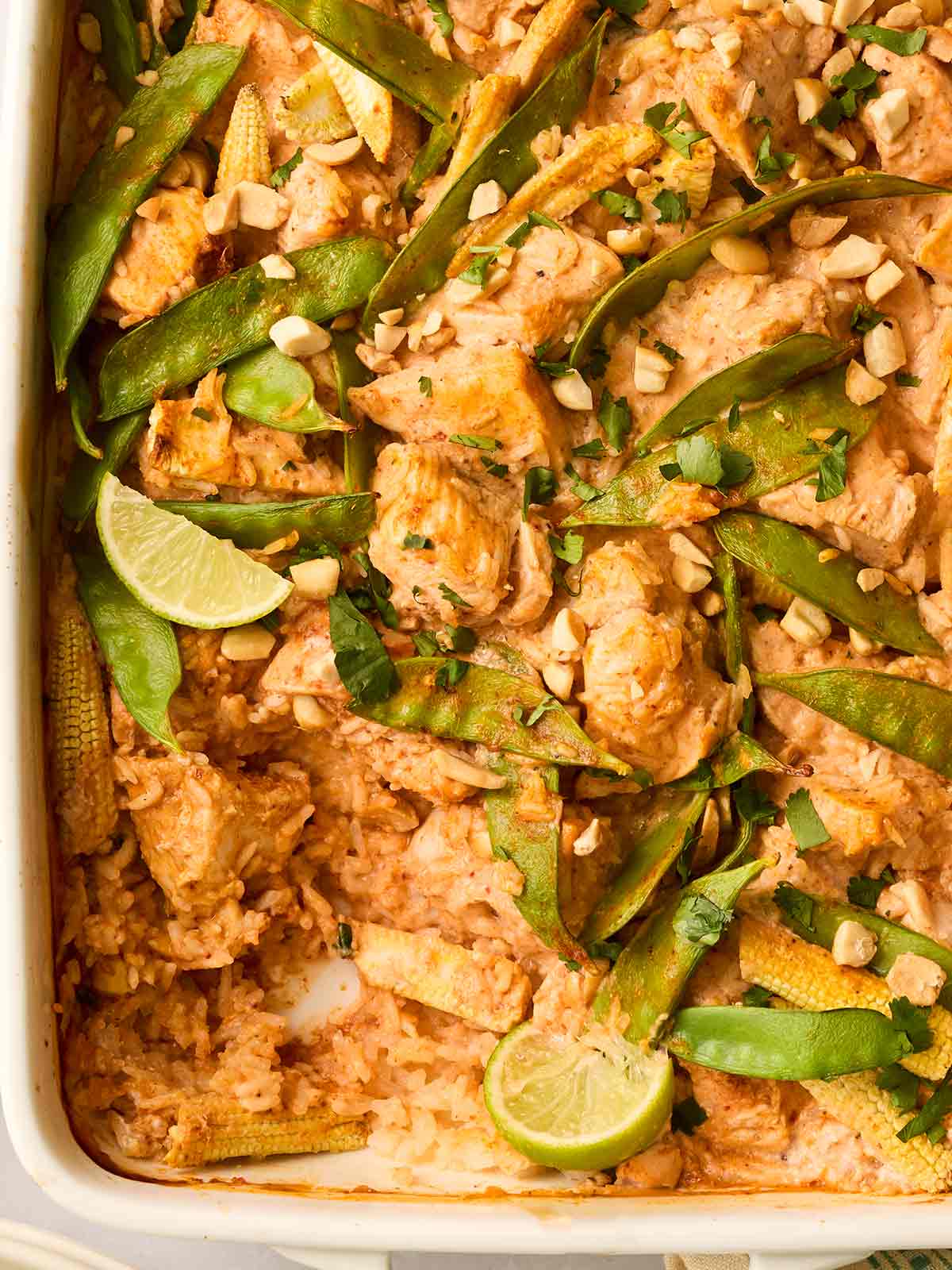 An oven dish filled with rice, chicken and vegetables.