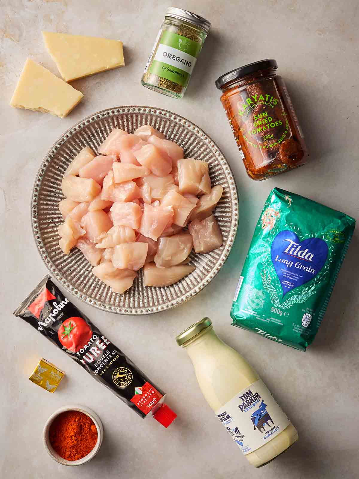 The ingredients of for making an easy chicken and rice dinner laid out on a table.