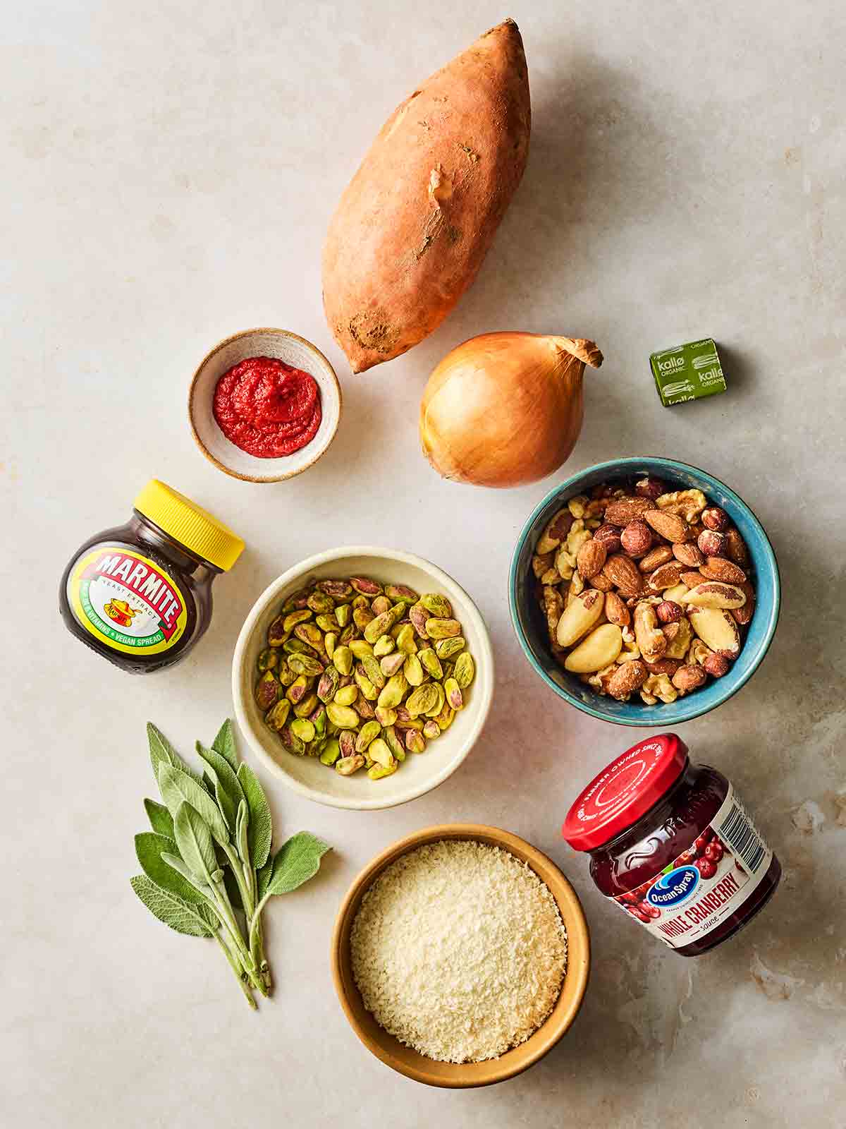 The ingredients for making a nut roast laid out on a white surface from above.