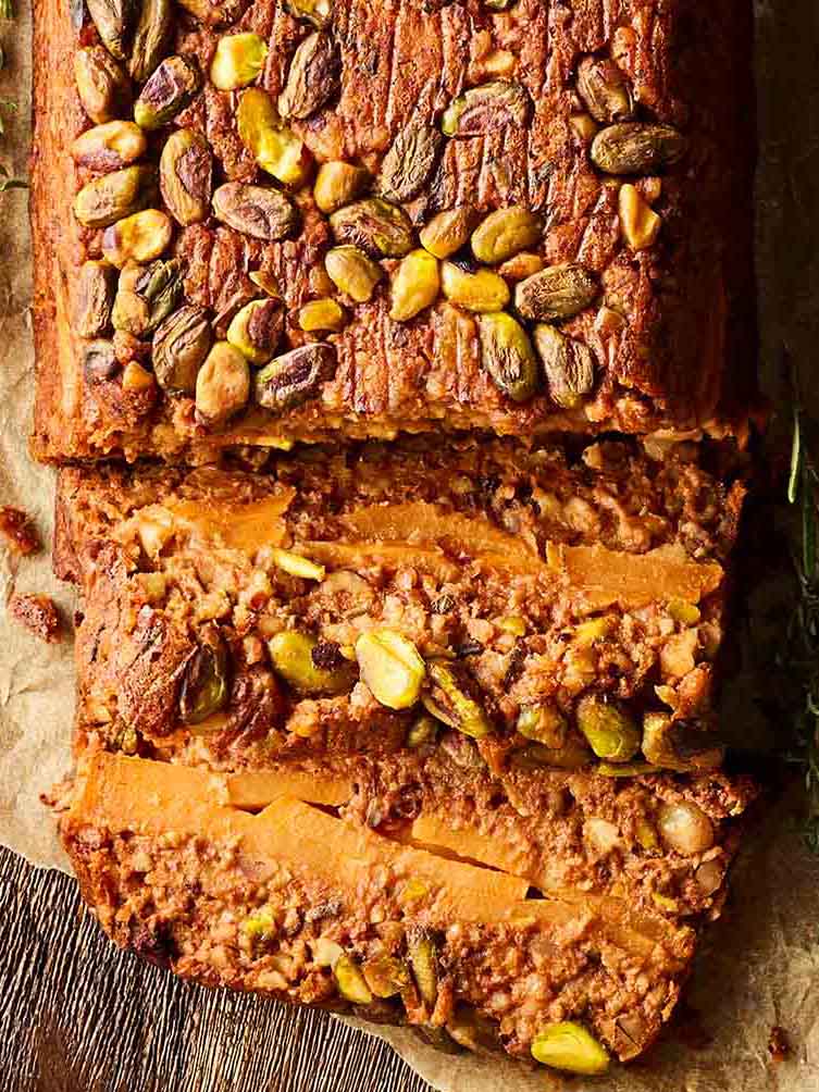 A close up of a nut roast, sliced and ready to serve.