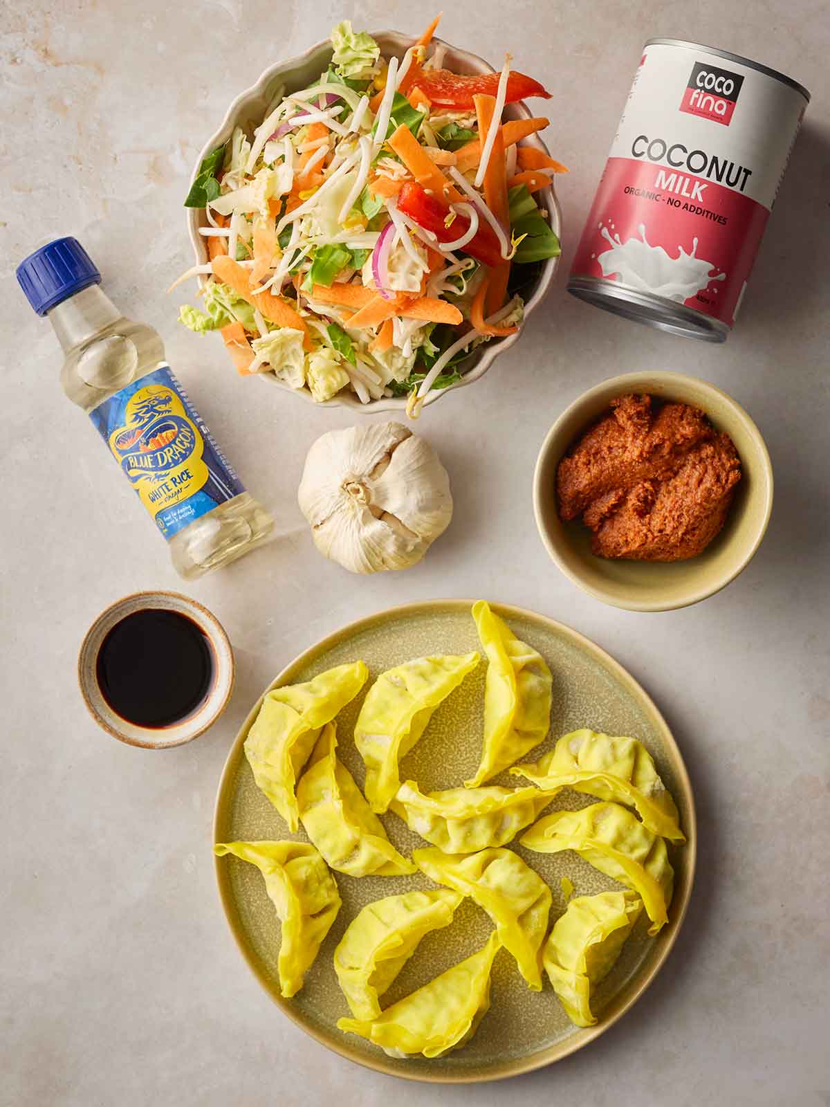 The ingredients for making One Pan Baked Dumplings laid out on a white counter top.