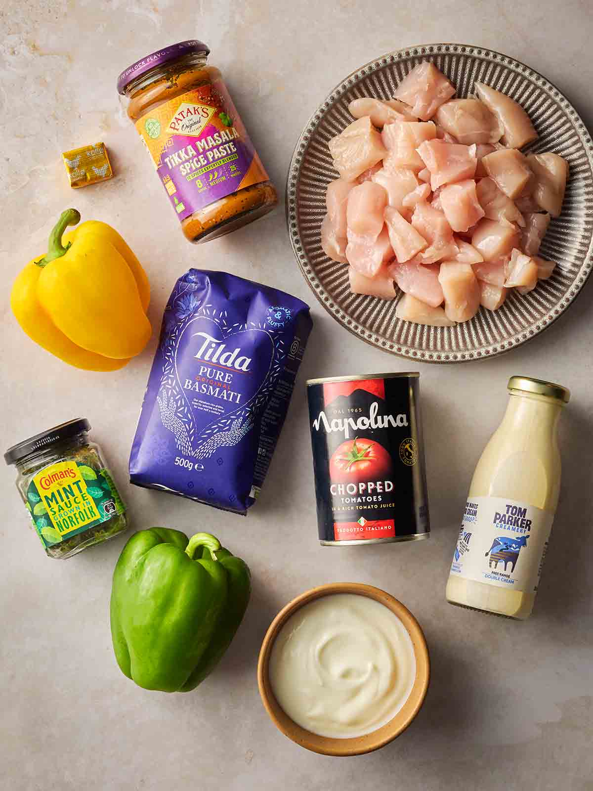 Ingredients for making Chicken Curry and Rice laid out on a white counter.