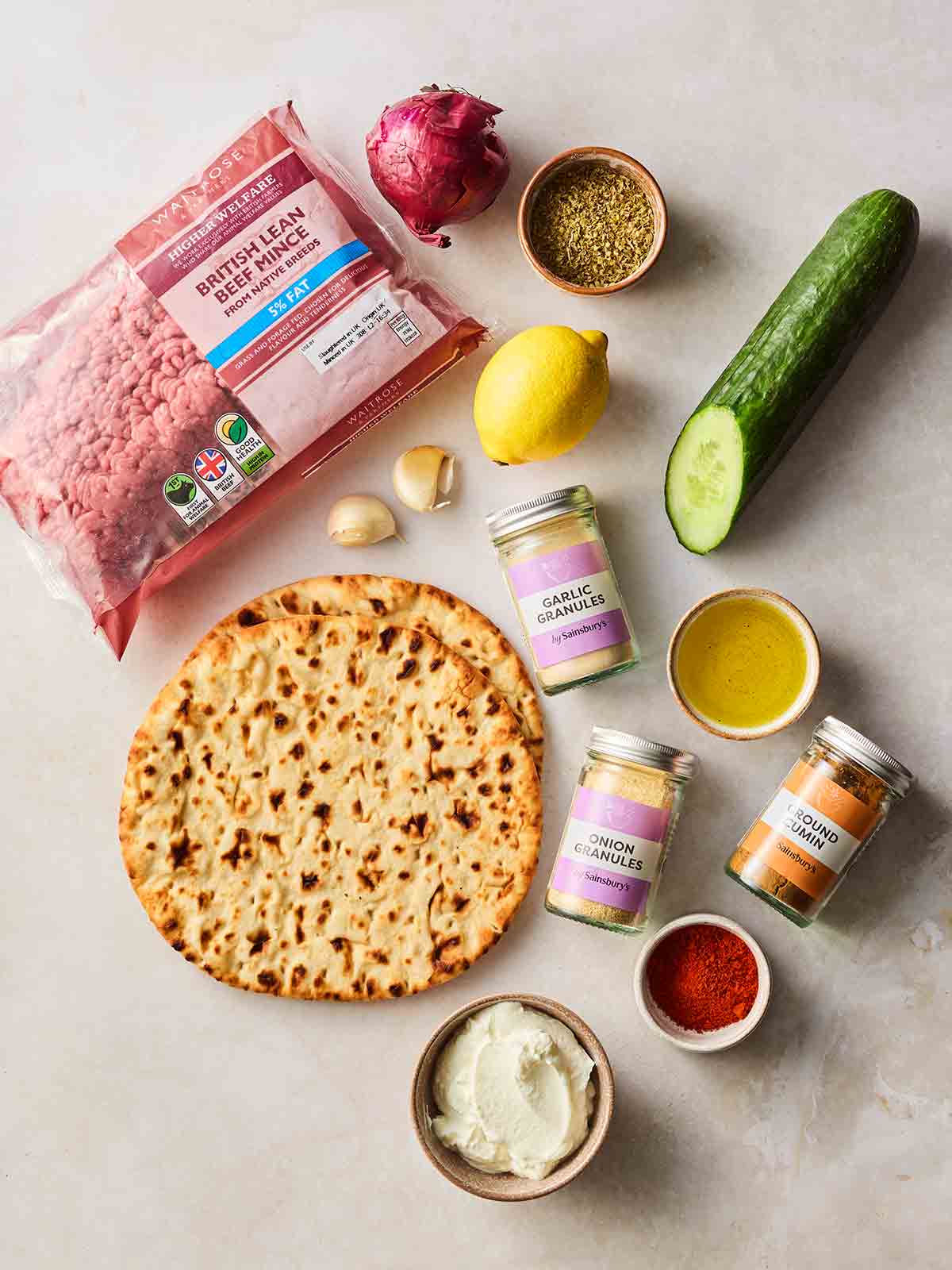 The ingredients for making a sheet pan kebab laid out in a white surface.
