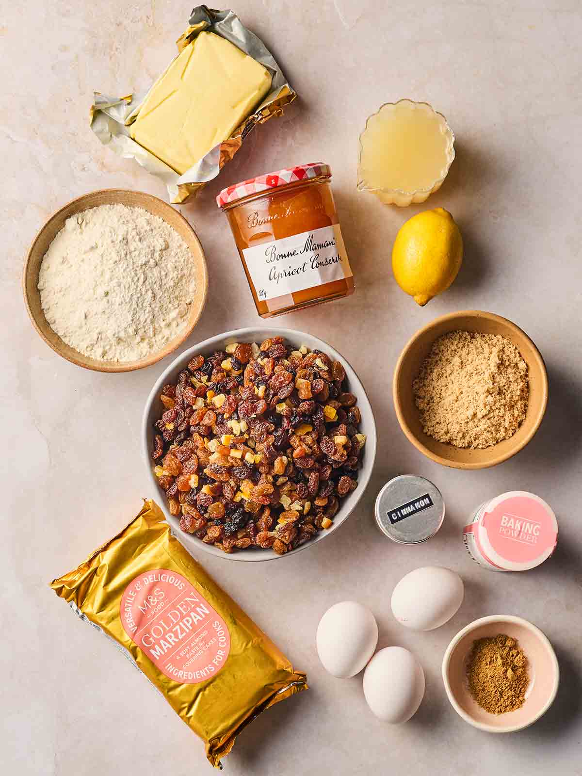 The ingredients for making a Simnel Cake laid out on a white surface.