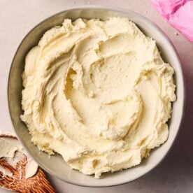 A bowl of fresh buttercream frosting, ready to use for cakes.