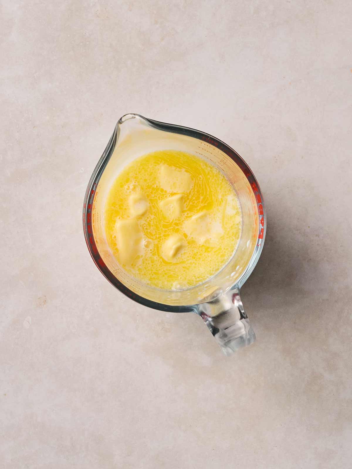 A Pyrex jug with milk and melted butter in.