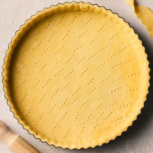 A pie dish with unbaked shortcrust pastry in, ready to bake.