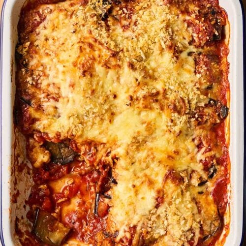 A baked Parmigiana di Melanzane on a table, ready to serve.