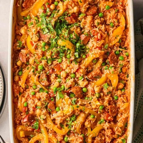An oven dish with a one pot baked chorizo with rice inside, ready to dish up.